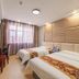 OYO Hexi Hotel in Zhangye guest room with two twin beds, desk, TV, and window with curtains