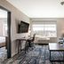Four Points by Sheraton Elkhart guest room with sofa, desk, TV and city view window