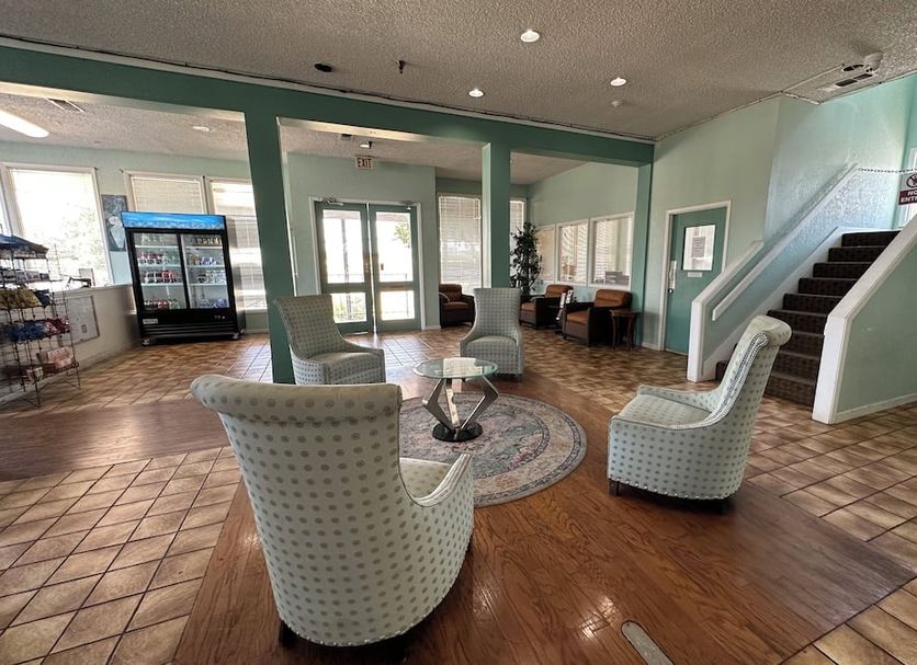 Home Suites Hill Country in San Antonio lobby seating area with stairs and tiled flooring