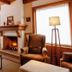 Hotel Solar d'Izabel in Campos do Jordão lounge with fireplace, leather chairs and large windows