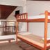 Pousada Innova in Natal loft-style room with wooden bunk beds and mezzanine seating area