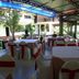 Grand Crown Hotel in Anuradhapura outdoor dining area with tables and red-and-white chair covers