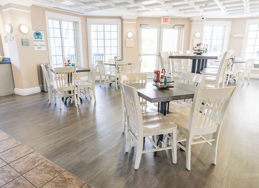 Amelia Hotel at the Beach in Fernandina Beach breakfast area with white tables and chairs