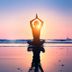 La Maison Ottomane, Chania: person meditating at sunset on a beach with ocean reflection