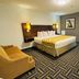 Baymont by Wyndham Chicago/Calumet City guest room with king bed, sofa, desk and TV in Calumet City