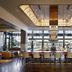 Hotel Vin, Grapevine, Autograph Collection lobby bar with long counter, high stools and dramatic ceiling