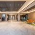 Orange Hotel Beijing Japan Medical University lobby with reception desk, seating area and elevators in Beijing