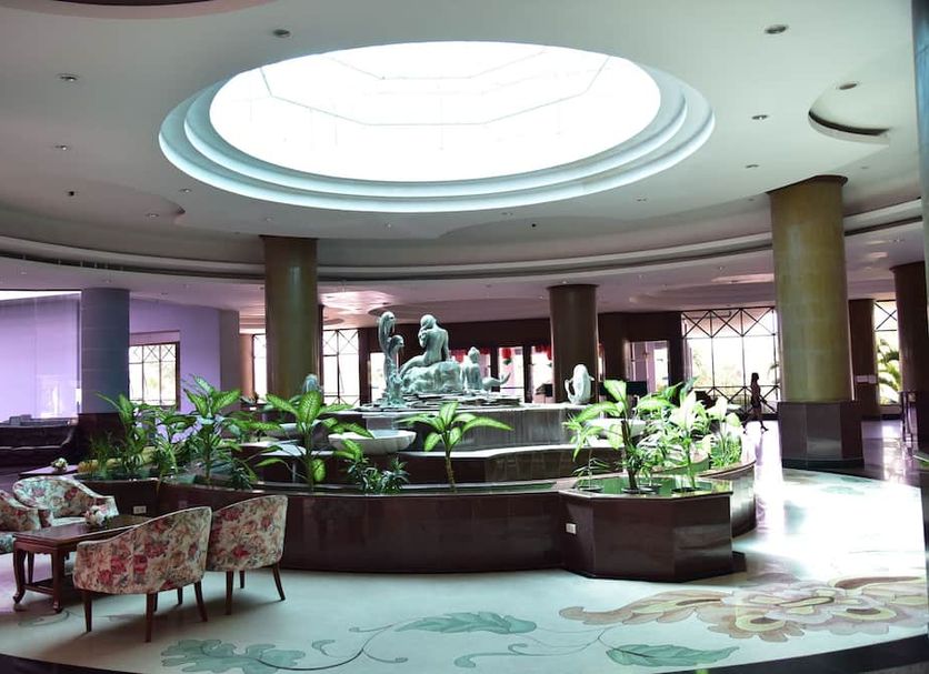 BP Samila Beach Hotel and Resort lobby with central fountain, skylight and seating in Songkhla