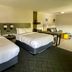 Comfort Inn Rutland - Killington room with two beds and seating area in Rutland