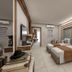 Batihan Beach Resort & Spa in Kusadasi guest room with twin beds, modern wood accents and a sitting area