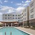 Hyatt House Boulder/Broomfield outdoor pool with lounge chairs and hotel building in Broomfield