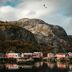Nusfjord Village & Resort in Ramberg with red waterfront cabins beneath rocky mountains
