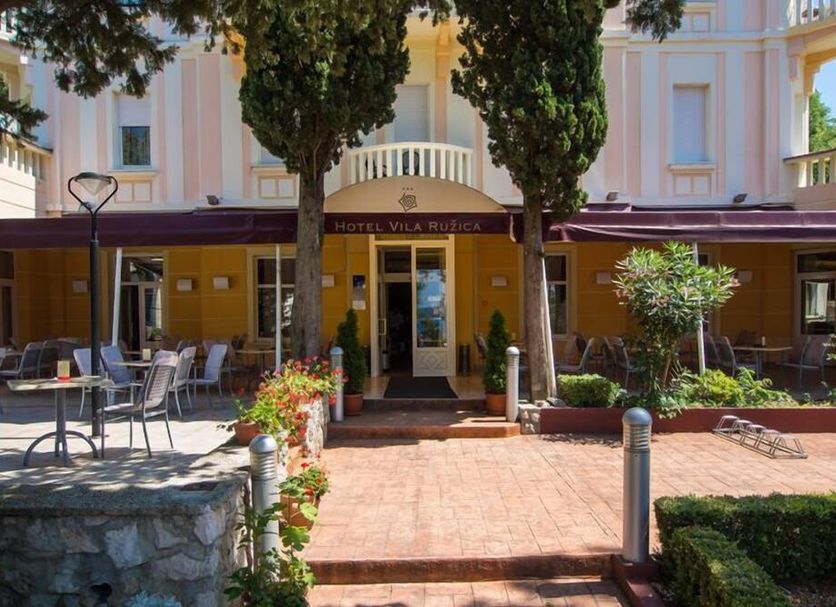 Hotel Villa Ruzica in Crikvenica exterior with courtyard dining terrace and entrance