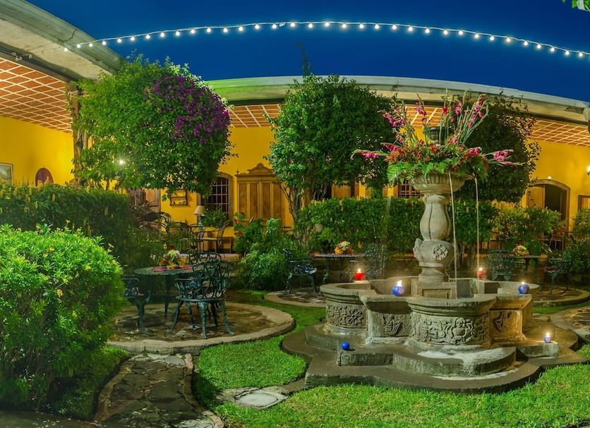Hotel Casa Antigua by Ahs courtyard garden in Antigua with a stone fountain and string lights