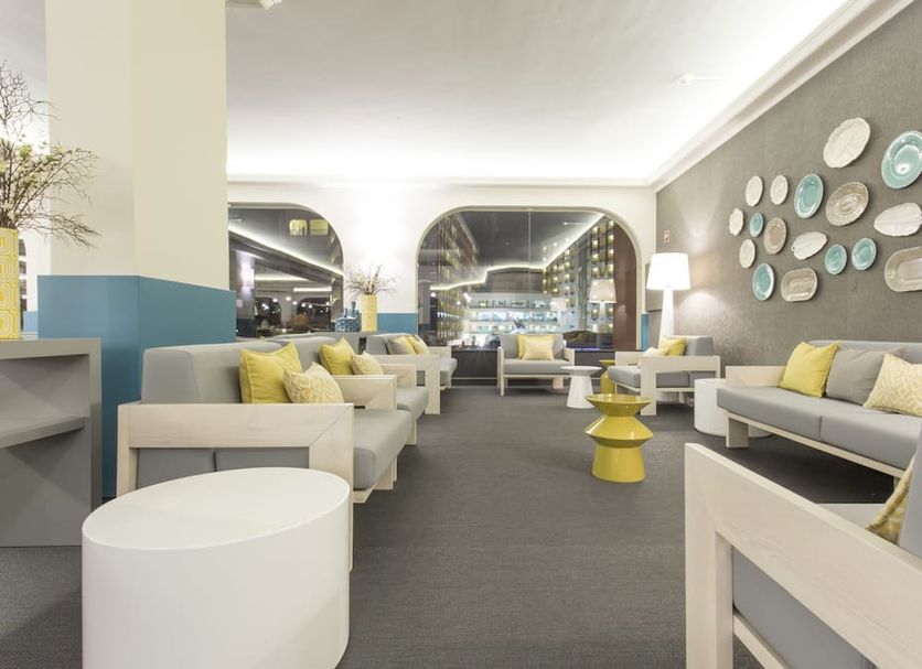 Ukino Palmeiras Village in Porches: bright lounge seating area with arched windows and decorative wall plates