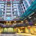 In One City Inn in Taichung City, atrium-style hotel courtyard with glass canopy and tall central tower