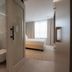 Harbor Hotel & Casino Curacao in Willemstad, bathroom with glass shower, vanity and bedroom view