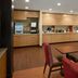 Towneplace Suites By Marriott Danville breakfast area with tables, chairs and coffee station