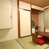 Hotel Kikuya in Hakodate guest room with tatami floor, low table, floor chairs, and curtained window