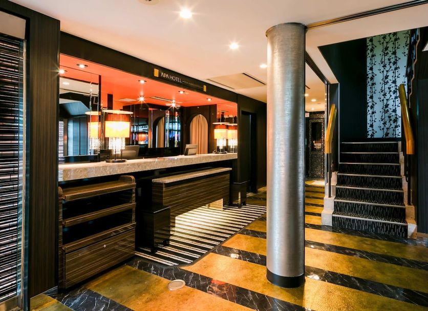 Apa Hotel Nagasaki Ekimae lobby with striped floor, reception desk and staircase in Nagasaki