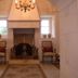 Masseria Magli Resort in Martina Franca, stone hallway with chandelier and fireplace alcove