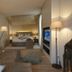 Bad Bubendorf Design & Lifestyle Hotel guest room with bed, sofa, TV and floor lamps