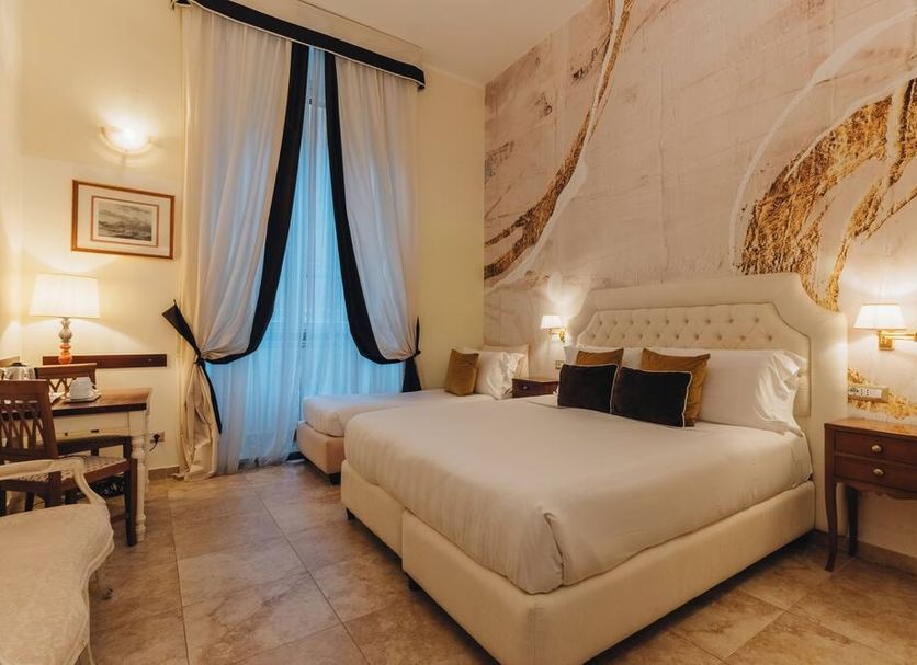 Hotel Le Clarisse al Pantheon guest room in Rome with king bed, tiled floor, and draped window