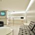 60 West Hotel, Hong Kong lounge with black and white sofas, round table, and compact bar area