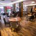 Anemon Ege Hotel in Izmir dining area with round tables, chairs, wood flooring, and a bar