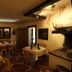 Haus Wartenberg in Salzburg dining room with set tables, wooden chairs, and warm lighting