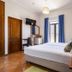 Residencial Mares in Tavira guest room with double bed, balcony doors, TV and wood furnishings