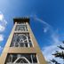 The Nagoya Plasa Redpartner in Batam, low-angle view of a tall hotel tower against a blue sky
