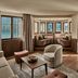 Grace La Margna St Moritz lounge with bay windows, mountain views, wood floors and seating