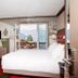 Hotel Bristol Verbier, Bagnes: cozy guest room with bed and open balcony door to mountain views