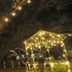 Fairfield Manor Bed and Breakfast in Shreveport lit at night with string lights and a glowing garden gazebo