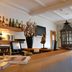 Fletcher Badhotel Egmond aan Zee bar and reception desk with bottles and lantern decor