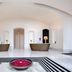 The Roseate New Delhi lobby with reception desks and a flower-filled centerpiece