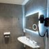 Bhoma Bourges - Hôtel bathroom with walk-in shower, illuminated mirror and wall-mounted sink in Bourges