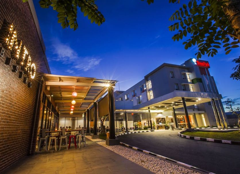 Treepark Hotel Banjarmasin exterior entrance with covered outdoor seating at dusk in Banjarmasin