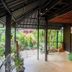 The Yuppi Hippi Beachpackers Hostel in Anjuna patio with greenery and covered outdoor seating area