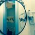 Sichelgaita Apartment in Salerno, wall mirror reflecting a bathroom with wall-mounted hair dryer