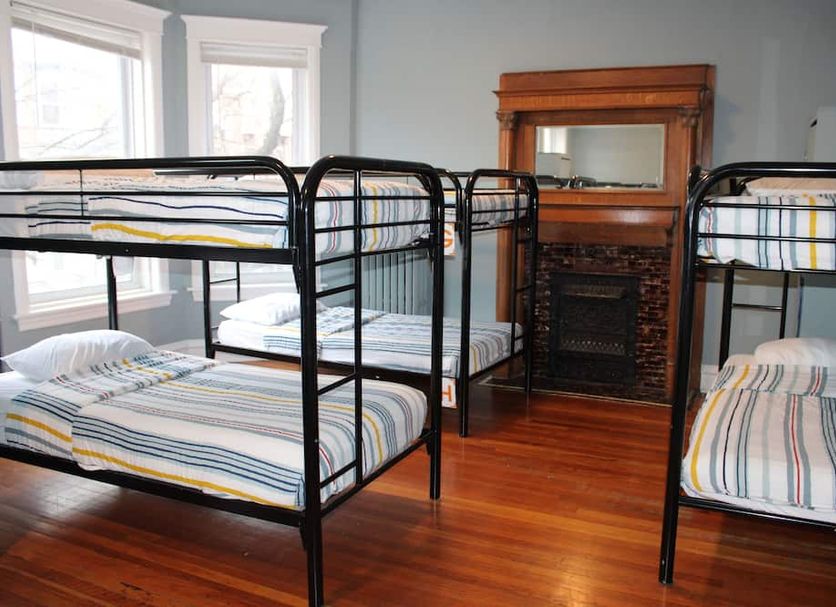 Wrigley Hostel Chicago dorm room with bunk beds, hardwood floors and a fireplace