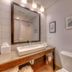 Country Inn & Suites by Radisson, Crystal Lake, IL bathroom with vanity, mirror, and toilet