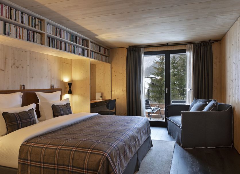 St-Alban Hotel & Spa in La Clusaz: cozy room with king bed, sofa, and balcony mountain view