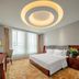 Fuxing Oriental Boutique Hotel Chifeng guest room with king bed, desk, and large window