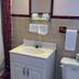Best Motel Bowling Green bathroom with sink, toilet, towels, and shower curtain