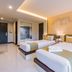 River Front Krabi Hotel in Krabi, twin beds in a modern guest room with warm lighting and wall art