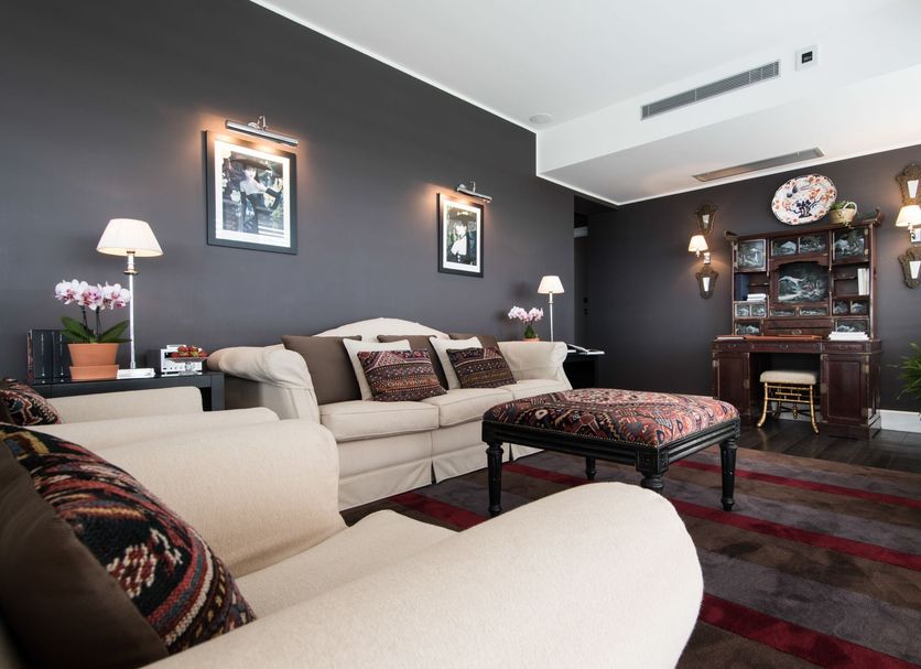Hotel Michelangelo & Day Spa in Montecatini Terme lounge with sofas, ottoman, desk and wall sconces