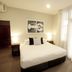 Hotel Bondi Sydney guest room with queen bed, bedside lamps and sheer curtains beside a window
