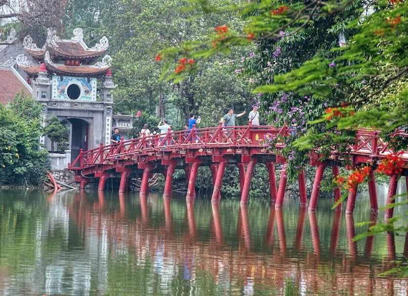 Rising Dragon Legend Hotel in Hanoi near a red bridge over a calm lake